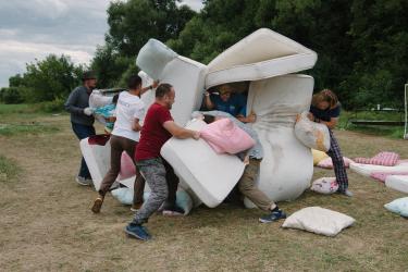 Theologians. Students fight with pillows and mattresses during the camp gathering.